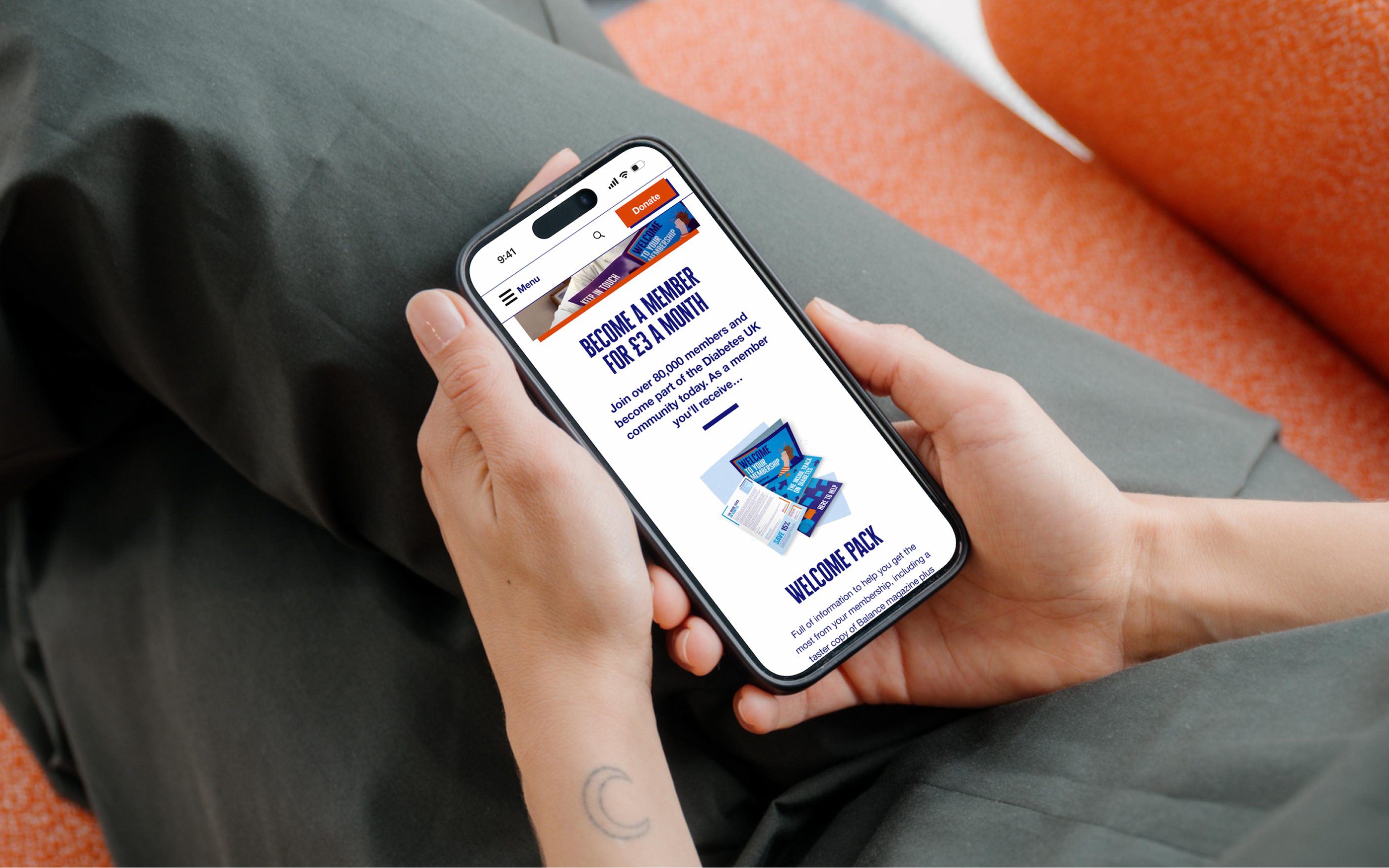 Person holding smartphone displaying Diabetes UK membership webpage with welcome pack promotion